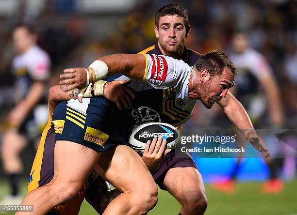 Scott Bolton of the Cowboys is tackled by Corey Parker of the Broncos during the NRL 1st Elimination Final match between the North Queensland Cowboys...