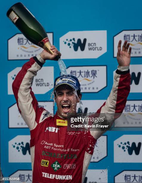 Audi Sport ABT driver Lucas di Grassi of Brazil celebrates on the podium after winning the inaugral FIA Formula E Beijing ePrix Championship race on...