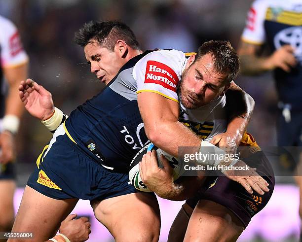 Scott Bolton of the Cowboys is tackled by Corey Parker of the Broncos during the NRL 1st Elimination Final match between the North Queensland Cowboys...