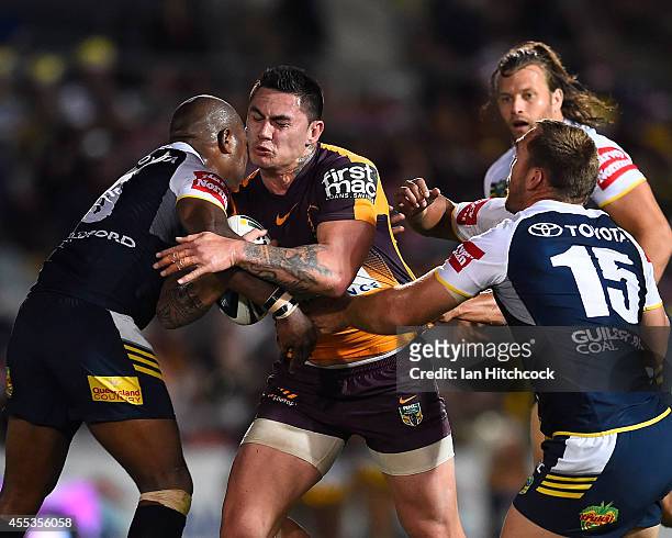 Daniel Vidot of the Broncos is tackled by Robert Lui and Scott Bolton of the Cowboys the NRL 1st Elimination Final match between the North Queensland...
