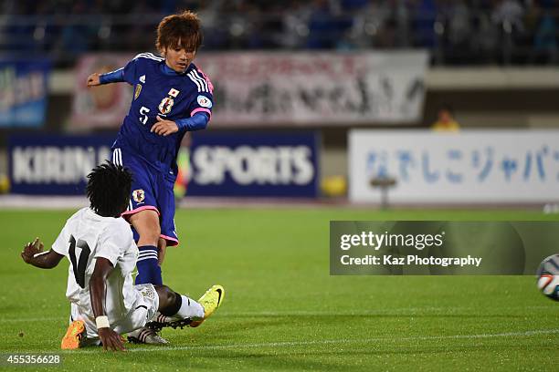 Kana Osafune of Japan scores Japan's 4th goal under the challenge from Portia Boakye of Ghana during the women's international friendly match between...