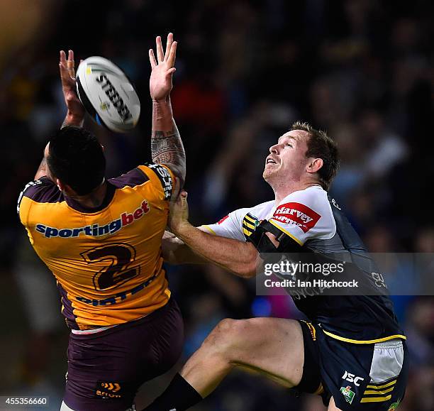 Michael Mogan of the Cowboys contests a high ball with Daniel Vidot of the Broncos during the NRL 1st Elimination Final match between the North...