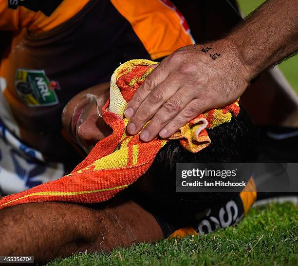 Justin Hodges of the Broncos recieves treatment after being injured during the NRL 1st Elimination Final match between the North Queensland Cowboys...