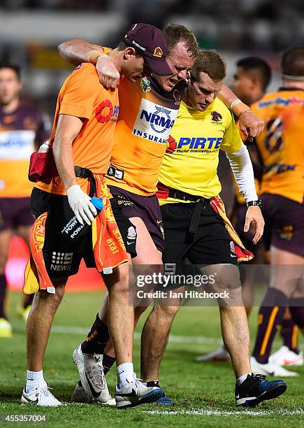 Martin Kennedy of the Broncos comes the field after being injured during the NRL 1st Elimination Final match between the North Queensland Cowboys and...