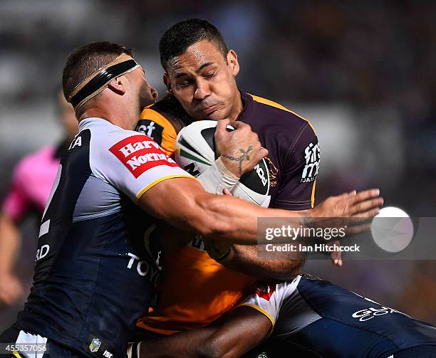 Justin Hodges of the Broncos is tackled by Tariq Sims of the Cowboys during the NRL 1st Elimination Final match between the North Queensland Cowboys...