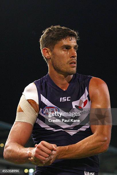 Garrick Ibbotson of the Dockers walks to the change rooms with a dislocation during the AFL 1st Semi Final match between the Fremantle Dockers and...