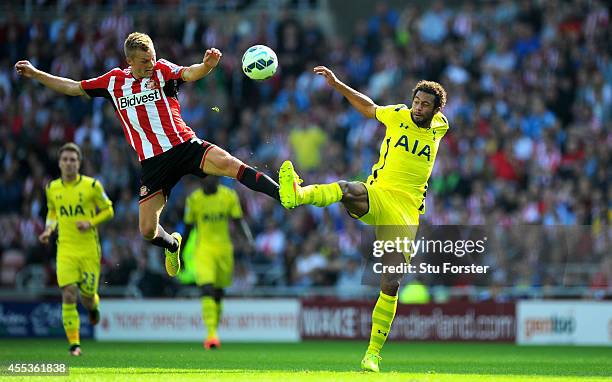 Sunderland player Sebastian Larsson challenges Moussa Dembele of Spurs during the Barclays Premier League match between Sunderland and Tottenham...