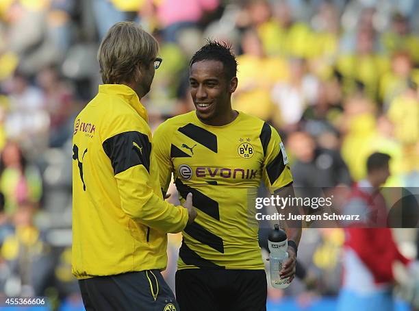 Headcoach Juergen Klopp of Dortmund hugs Pierre-Emerick Aubameyang after the Bundesliga match between Borussia Dortmund and SC Freiburg at Signal...