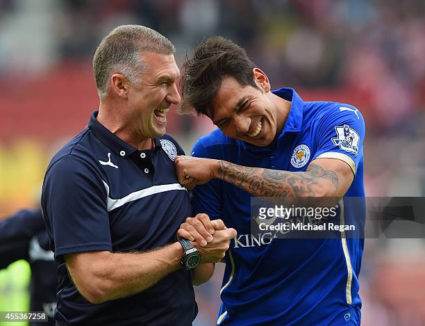 Manager Nigel Pearson of Leicester City celebrates with Leonardo Ulloa of Leicester City after victory during the Barclays Premier League match...
