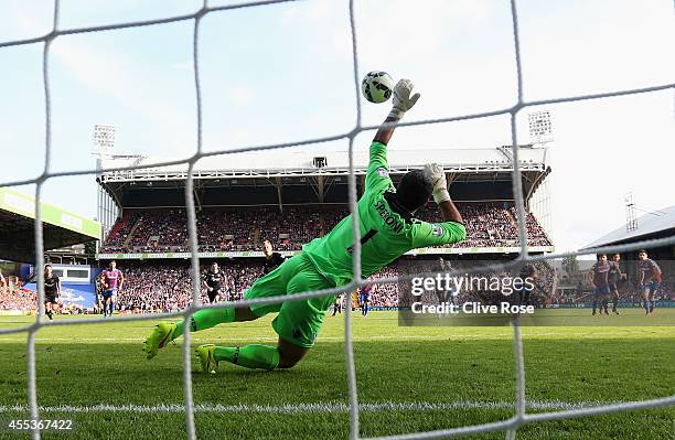 Julian Speroni of Crystal Palace saves a penalty from Scott Arfield of Burnley during the Barclays Premier League match between Crystal Palace and...