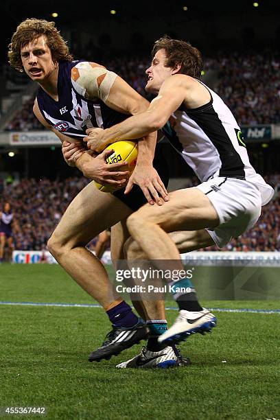 Nathan Fyfe of the Dockers gets tackled by Jared Polec of the Power during the AFL 1st Semi Final match between the Fremantle Dockers and the Port...