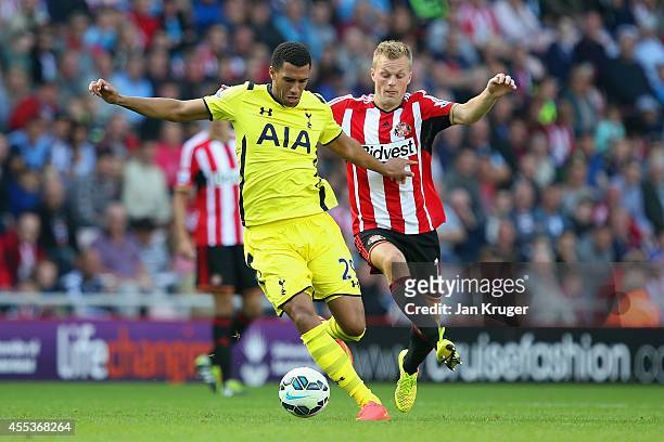 Etienne Capoue of Spurs is marshalled by Sebastian Larsson of Sunderland during the Barclays Premier League match between Sunderland and Tottenham...