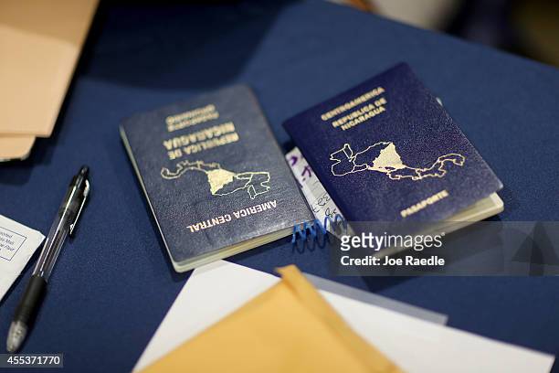 Nicaraguan passports are seen as people are helped apply for United States citizenship September 13, 2014 in Miami, Florida. The clinic put on by the...