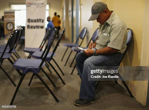 Hector Perez, originally from Guatemala, attends a citizenship clinic for assistance in applying for United States citizenship September 13, 2014 in...