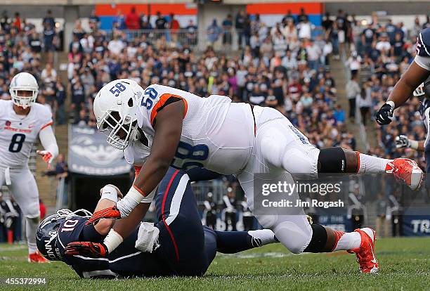 Robert Ash of the Boise State Broncos sacks Chandler Whitmer of the Connecticut Huskies in the second quarter against the Connecticut Huskies at...