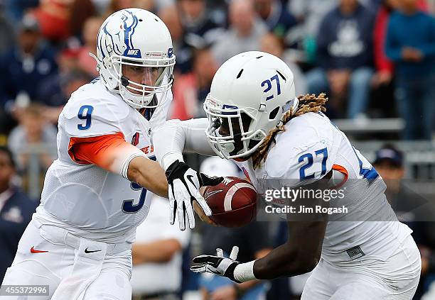 Grant Hedrick of the Boise State Broncos hands the ball to running back Jay Ajayi in the first quarter against the Connecticut Huskies at Rentschler...