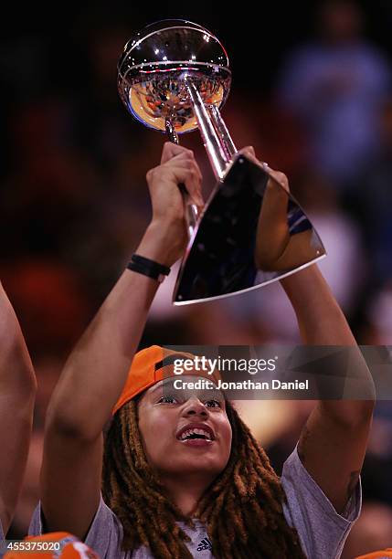Brittney Griner of the Phoenix Mercury holds the championship trophy after a win over the Chicago Sky during game three of the WNBA Finals at the UIC...