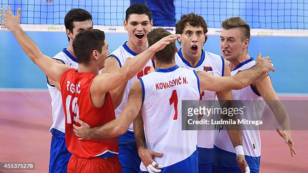 Serbia team reacts after winning point during the FIVB World Championships match between Serbia and France on September 13, 2014 in Lodz, Poland.