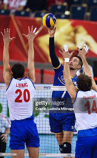 France's Kevin Tillie attacks against Serbia's Srecko Lisinac and Aleksandar Atanasijevic during the FIVB World Championships match between Serbia...