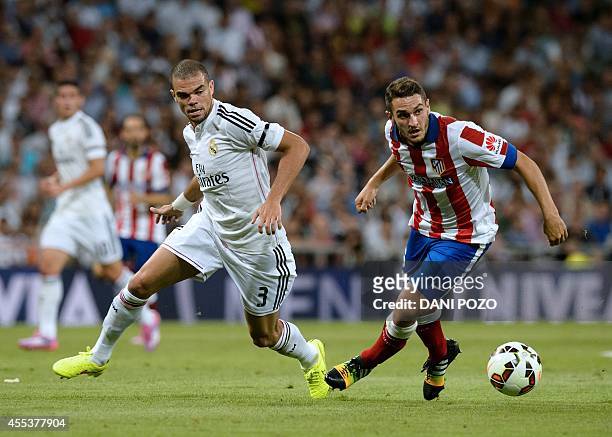 Real Madrid's Portuguese defender Pepe vies with Atletico Madrid's midfielder Koke during the Spanish league football match Real Madrid CF vs Club...