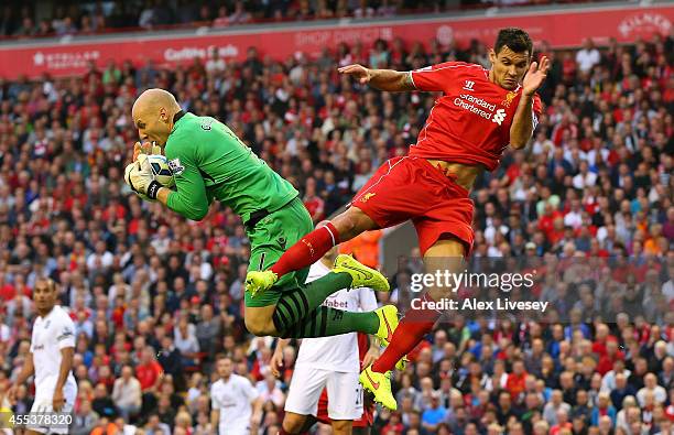 Dejan Lovren of Liverpool challenges Brad Guzan of Aston Villa during the Barclays Premier League match between Liverpool and Aston Villa at Anfield...