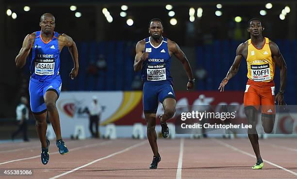 James Dasaolu of Great Britain and Europe wins the Mens 100m ahead of Richard Thompson of USA and Americas and Hua Wilfried Koffi of Ivory Coast and...