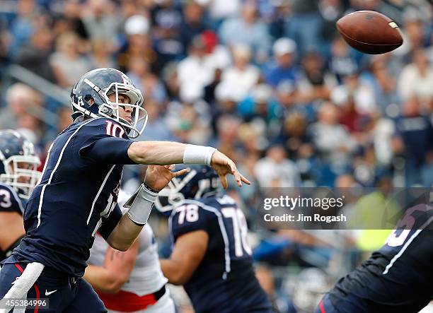 Chandler Whitmer of the Connecticut Huskies throws against the Boise State Broncos in the first half at Rentschler Field on September 13, 2014 in...