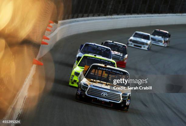Jeb Burton, driver of the Estes/Carolina Nut Company Toyota, leads a pack of trucks during the NASCAR Camping World Truck Series Lucas Oil 225 at...