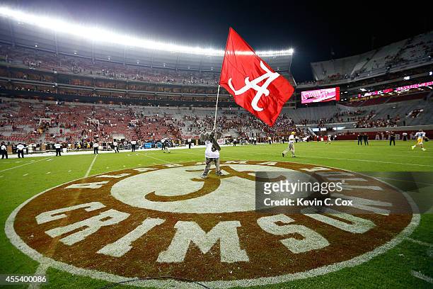 Big Al, mascot of the Alabama Crimson Tide, waves the flag after their 52-12 win over the Southern Miss Golden Eagles at Bryant-Denny Stadium on...