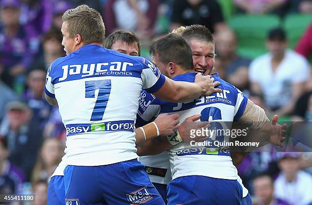 Greg Eastwood of the Bulldogs is congratulated by team mates after scoring a try during the NRL 2nd Elimination Final match between the Melbourne...