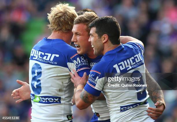 Trent Hodkinson of the Bulldogs is congratulated by team mates after scoring a try during the NRL 2nd Elimination Final match between the Melbourne...