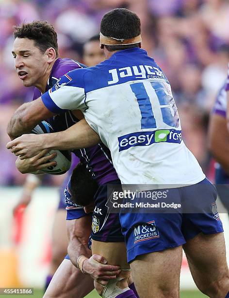 Billy Slater of the Storm is tackled by Dean Finucane of the Bulldogs during the NRL 2nd Elimination Final match between the Melbourne Storm and the...