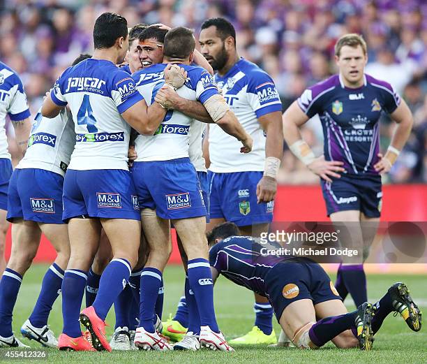 Dale Ficucane of the Bulldogs is hugged after forcing Billy Slater of the Storm to drop the ball from his tackle during the NRL 2nd Elimination Final...