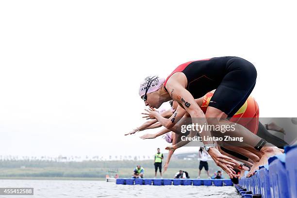 Emma-Kate Lidbury of Great Britain jumps into the water during the swimming stage of the 2014 Beijing International Triathlon at Beijing Garden Expo...