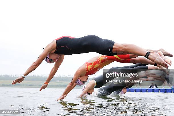 Emma-Kate Lidbury of Great Britain jumps into the water during the swimming stage of the 2014 Beijing International Triathlon at Beijing Garden Expo...