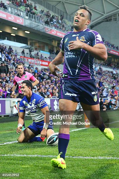 Tim Lafai of the Bulldogs reacts after scoring a try next to Will Chambers of the Storm during the NRL 2nd Elimination Final match between the...