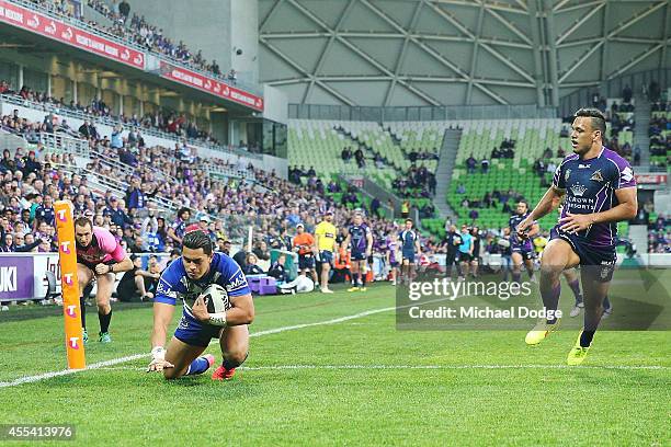 Tim Lafai of the Bulldogs scores a try next to Will Chambers of the Storm during the NRL 2nd Elimination Final match between the Melbourne Storm and...