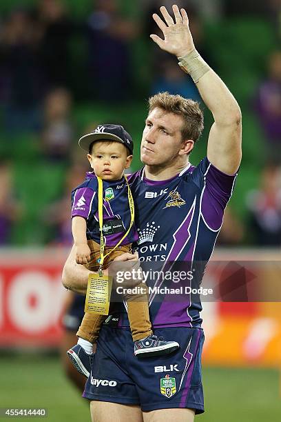 Ryan Hoffman of the Storm waves to the crowd with his son after playing his last game with the club during the NRL 2nd Elimination Final match...