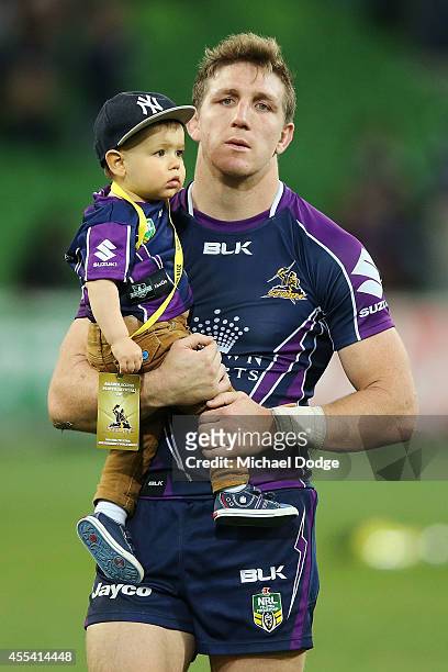 Ryan Hoffman of the Storm walks off the gorund with his son after playing his last game with the club during the NRL 2nd Elimination Final match...
