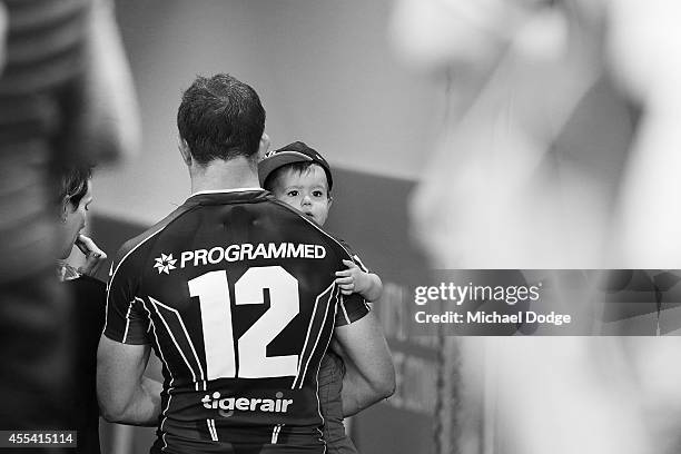 Ryan Hoffman of the Storm walks off the gorund with his son after playing his last game with the club during the NRL 2nd Elimination Final match...