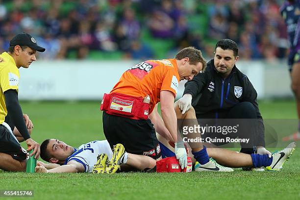 Pat O'Hanlon of the Bulldogs is attended to by trainers after injuring his leg during the NRL 2nd Elimination Final match between the Melbourne Storm...