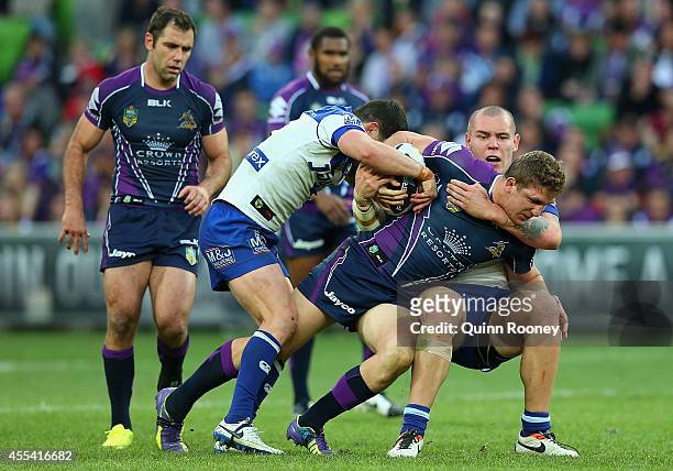 Ryan Hoffman of the Storm is tackled by David Klemmer of the Bulldogs during the NRL 2nd Elimination Final match between the Melbourne Storm and the...