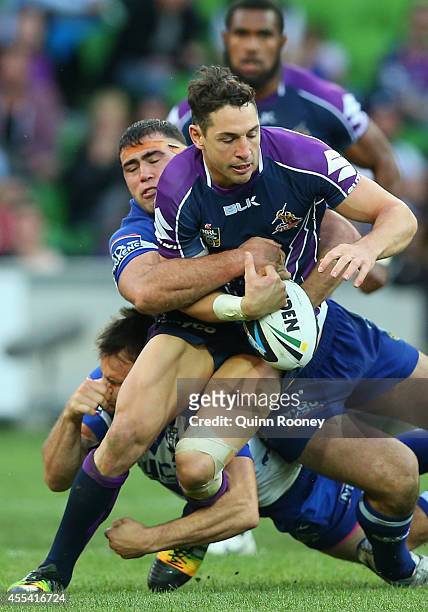 Billy Slater of the Storm is tackled by Dale Finucane of the Bulldogs during the NRL 2nd Elimination Final match between the Melbourne Storm and the...