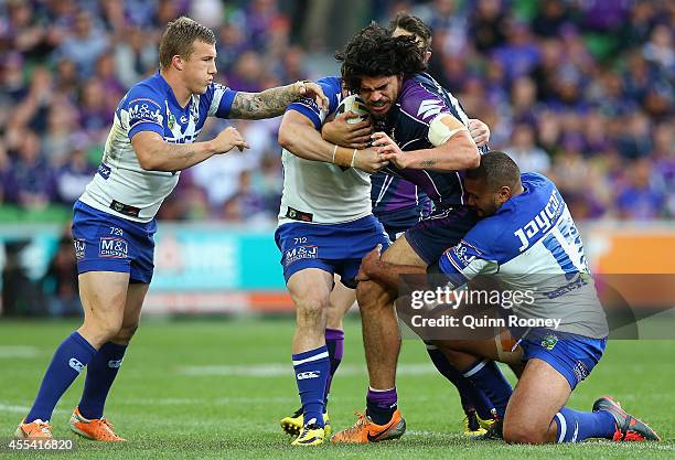 Tohu Harris of the Storm is tackled during the NRL 2nd Elimination Final match between the Melbourne Storm and the Canterbury Bankstown Bulldogs at...