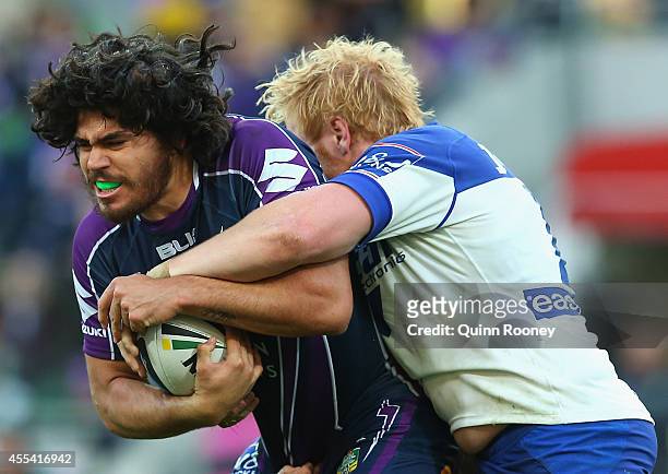 Tohu Harris of the Storm is tackled by James Graham of the Bulldogs during the NRL 2nd Elimination Final match between the Melbourne Storm and the...