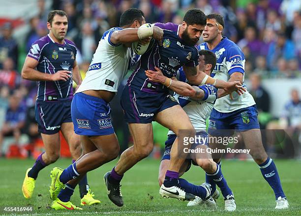 Jesse Bromwich of the Storm is tackled during the NRL 2nd Elimination Final match between the Melbourne Storm and the Canterbury Bankstown Bulldogs...
