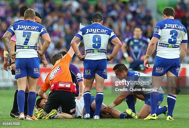 Pat O'Hanlon of the Bulldogs is attended to by trainers after injuring his leg during the NRL 2nd Elimination Final match between the Melbourne Storm...