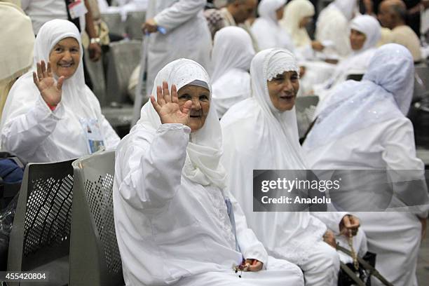 Two Muslim female prospective pilgrim wave their hands as they wait for the flight to the Muslim Holy Land at International Carthage Airport in...