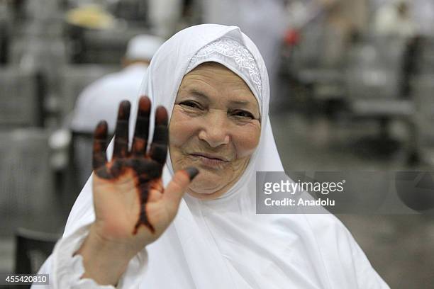 Muslim female prospective pilgrim wave her hand as they wait for the flight to the Muslim Holy Land at International Carthage Airport in Tunis,...