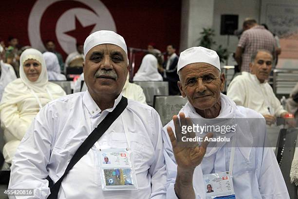 Muslim prospective pilgrims pose as they wait to flight for the Muslim Holy Land at International Carthage Airport in Tunis, Tunisia on September 13,...